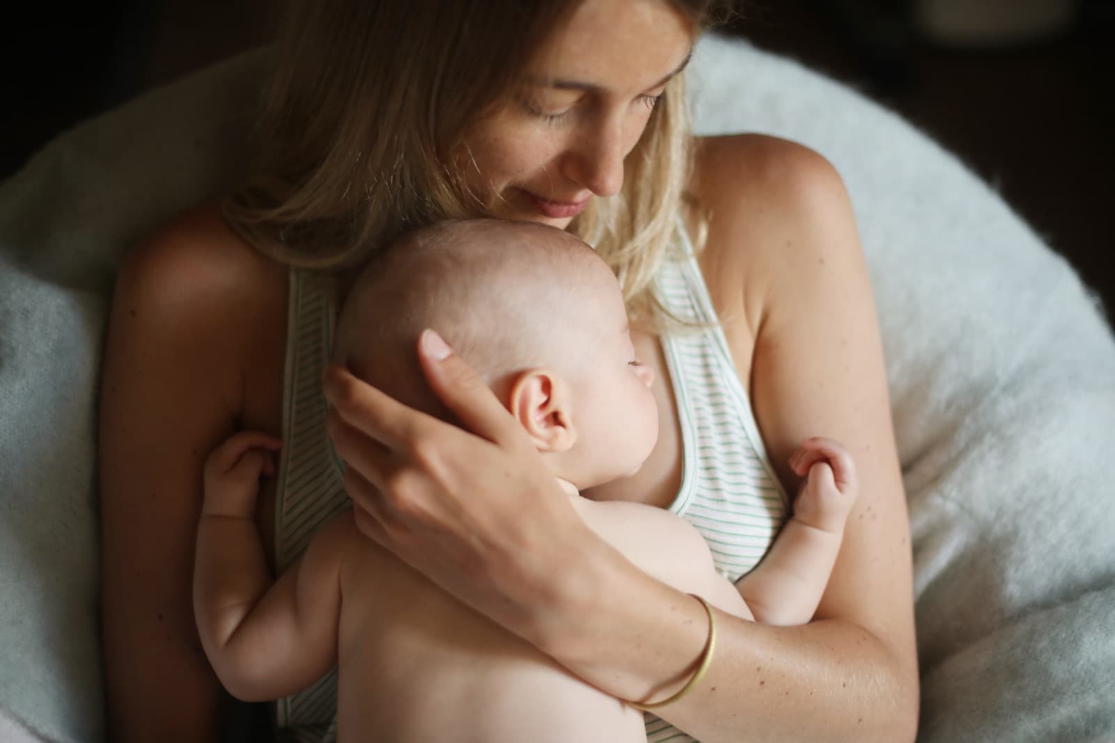 A mother smiling with her newborn
